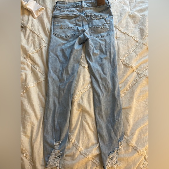 American Eagle light wash jeans with rips on legs and bottoms - Picture 2 of 2